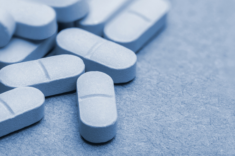 Macro shot of blue monochrome pills on isolated background. Pills and antidepressants.